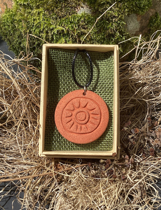 Megalithic Art Pendant with Sun Design.
