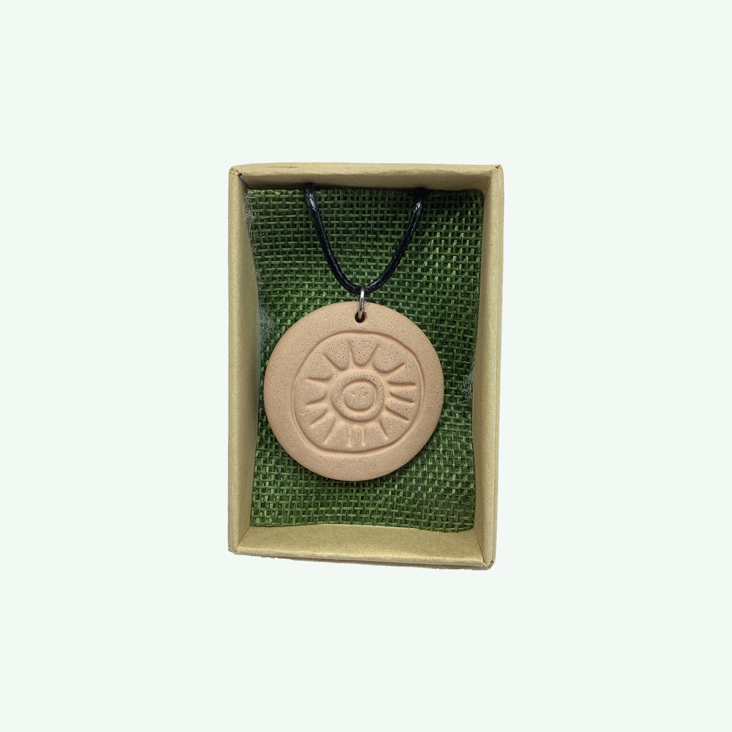 Megalithic Art Pendant with Sun Design.